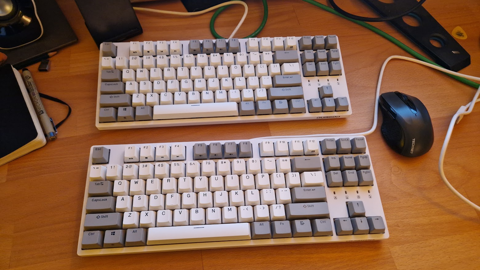 the top one has blue switches and the bottom, brown